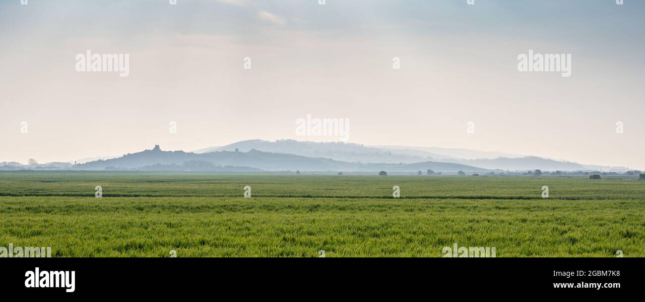 Uphill Beacon, Bleadon Hill and other hills of England's Mendips rise from the flat Somerset Levels near Brean. Stock Photo