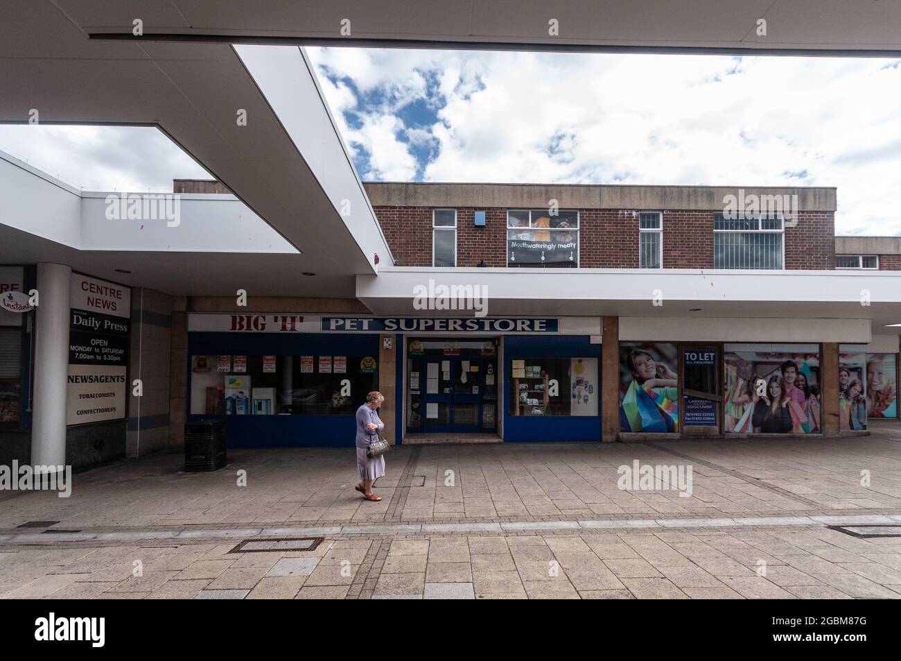 A woman walks past closed shops in the Quedam shopping precinct in Yeovil, Somerset, following the credit crunch recession in 2010. Stock Photo