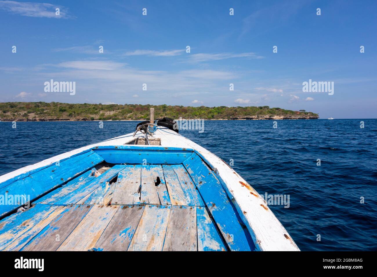 Old blue wooden fishing boat on the sea Stock Photo - Alamy