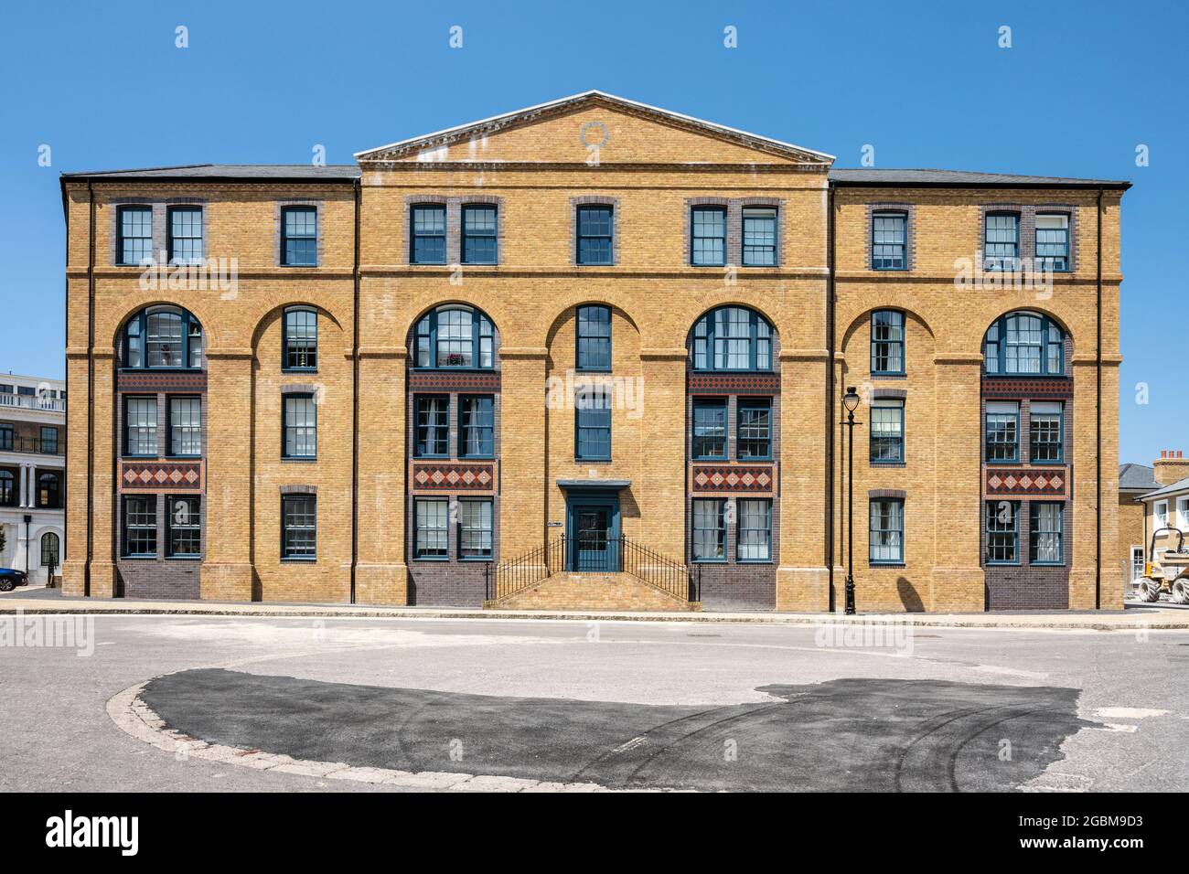 Sun shines on a new build apartment building in Poundbury new town