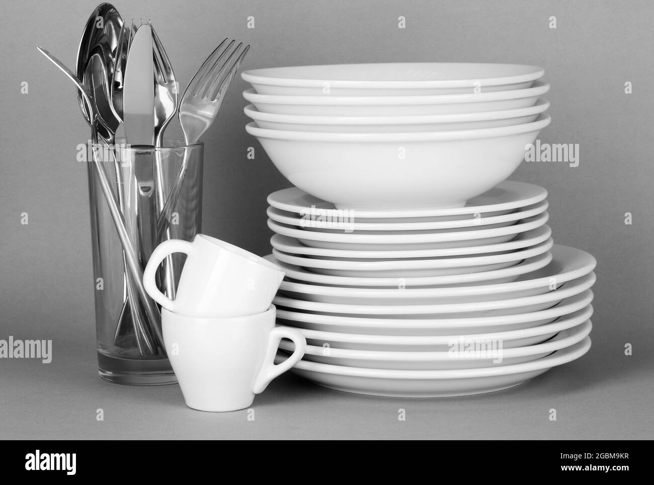 Clean white dishes on grey background Stock Photo Alamy
