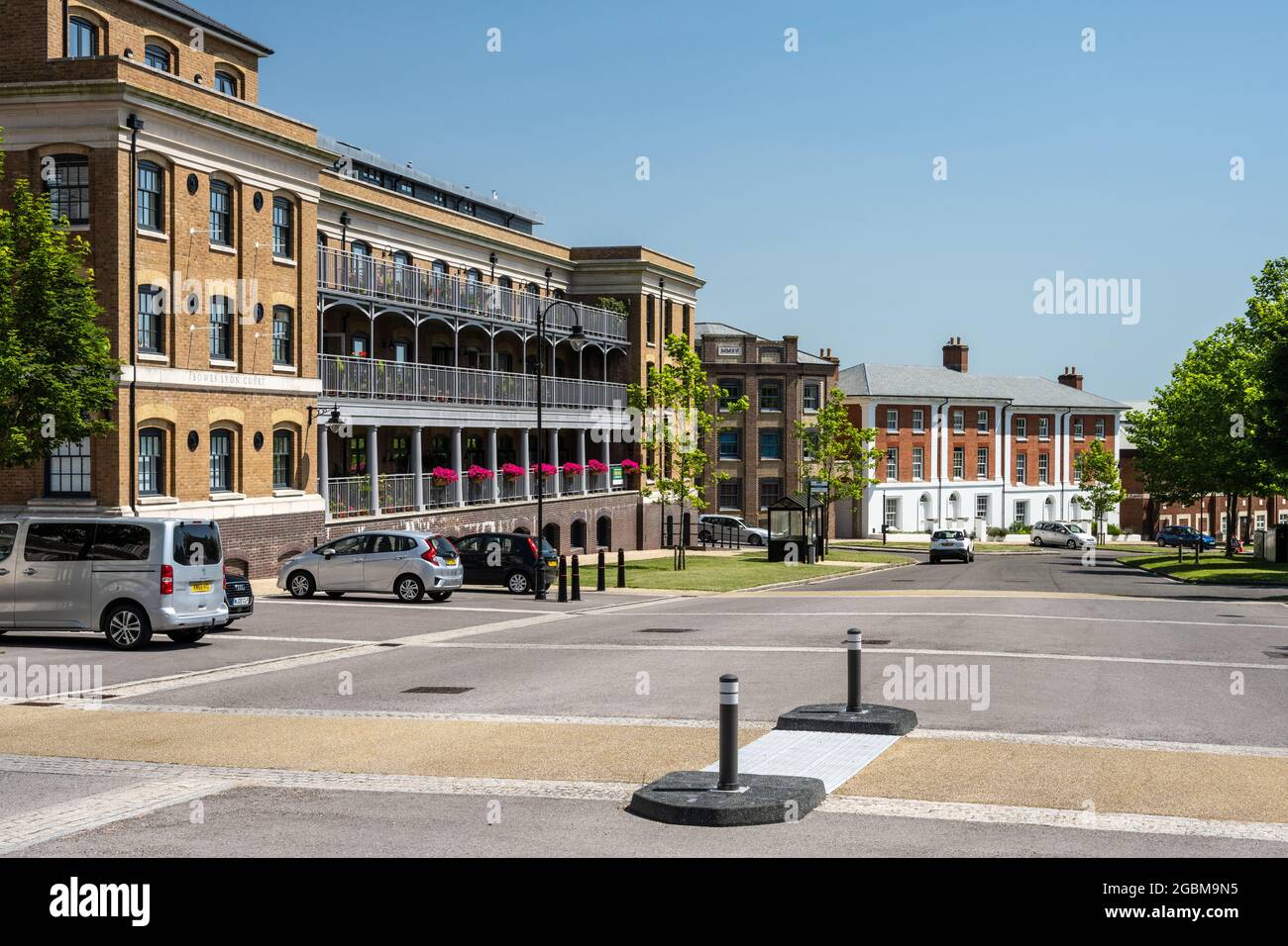 Sun shines on apartment buildings and town houses along Peverell Avenue in the centre of Poundbury new town. Stock Photo