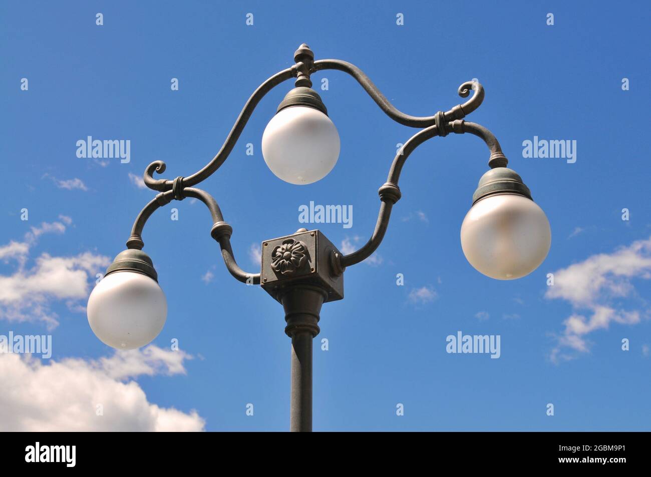 Close up of a beautiful vintage style street lamp of the city of Lugano in Switzerland against a blue sky Stock Photo