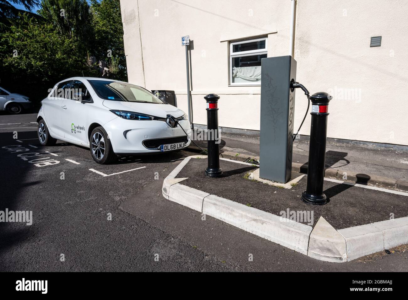 An electric 'car club' share car charges at an on-street charger in a residential street in Easton, Bristol. Stock Photo
