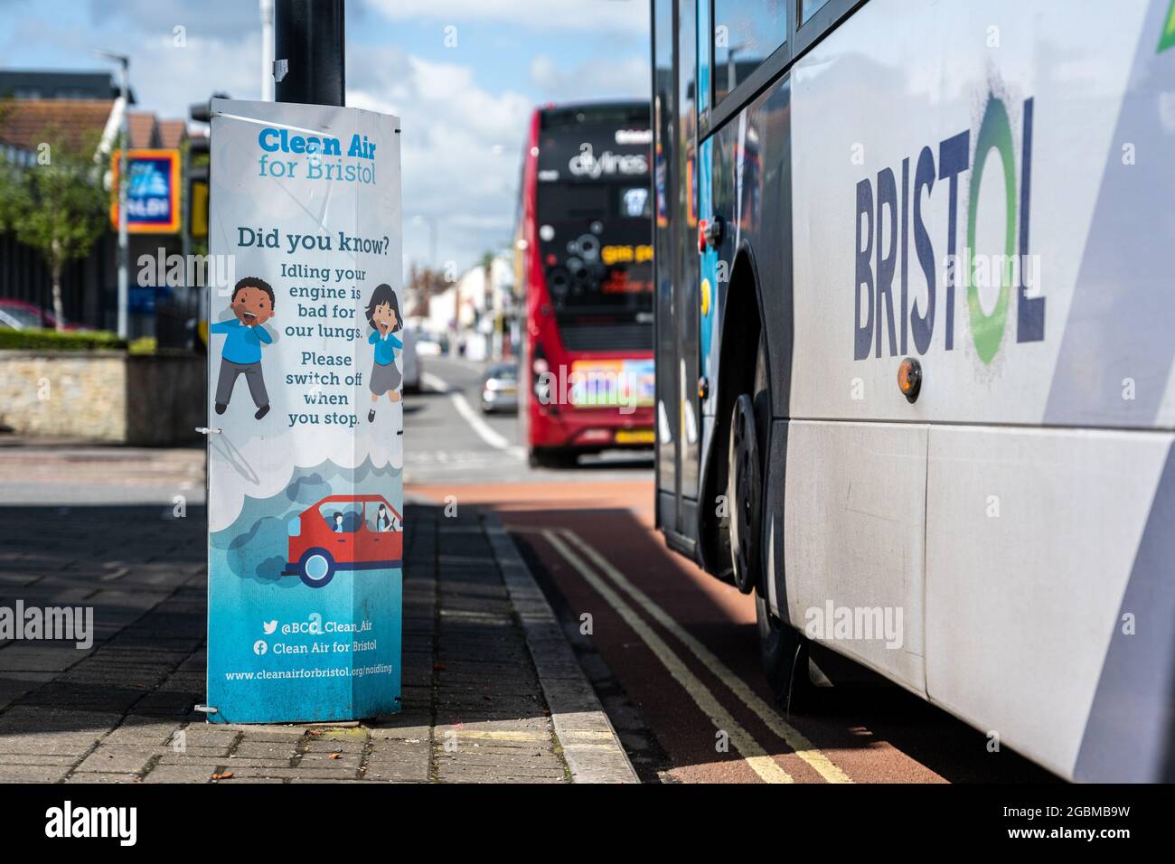A 'Clean Air' poster asks motorists to switch off their engines while idling at a junction on Fishponds Road in Bristol. Stock Photo