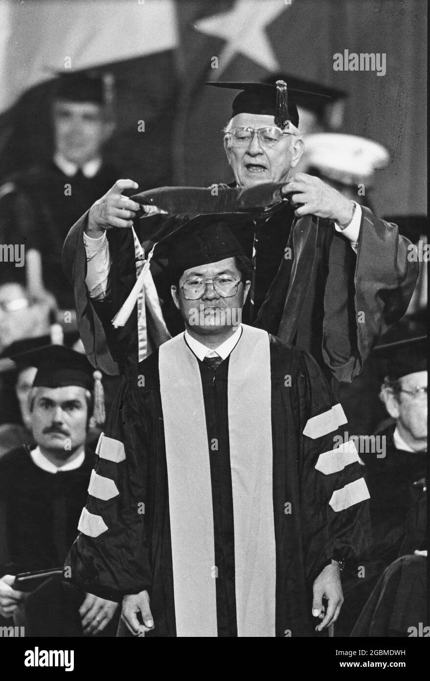 San Antonio Texas USA, circa 1990: PhD candidate receives his hood during commencement ceremony at  the University of Texas at San Antonio.  ©Bob Daemmrich Stock Photo