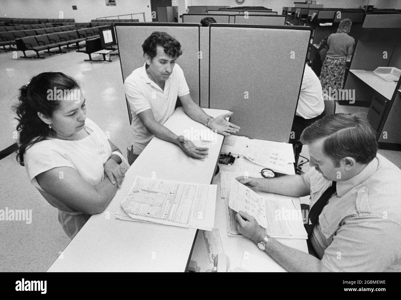 Austin, Texas USA, circa 1990: Undocumented immigrants at the Austin Immigration and Naturalization (INS) Legalization Center apply for amnesty applications. ©Bob Daemmrich Stock Photo