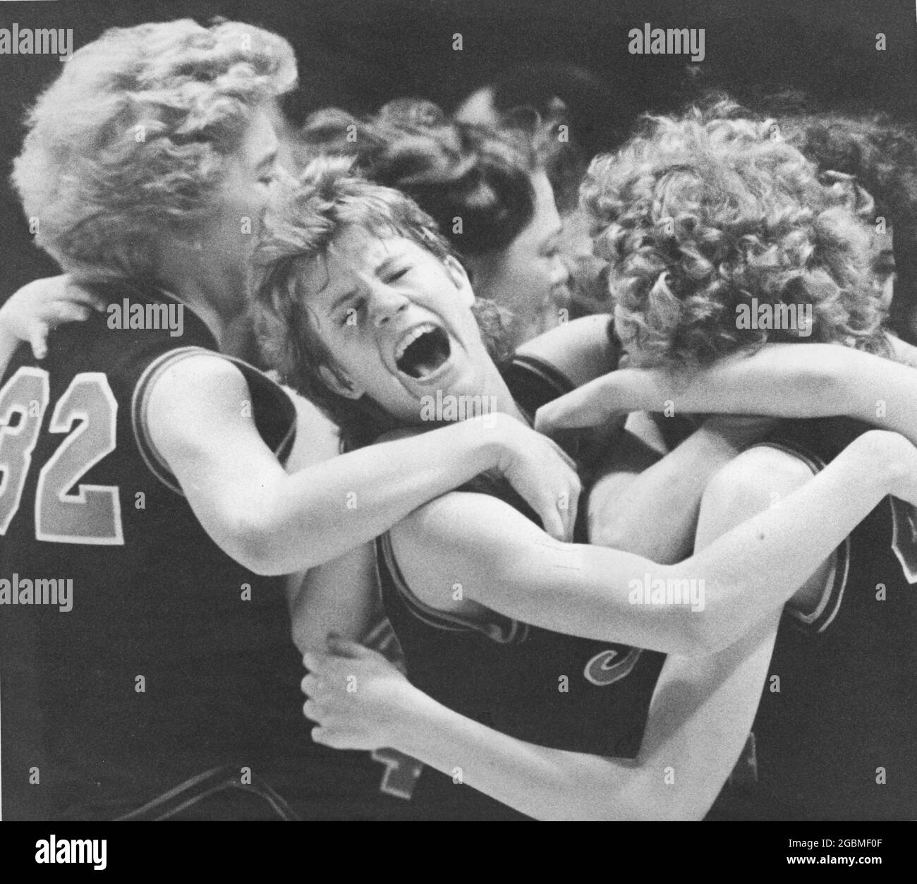 Austin, Texas USA, circa 1989: Excited girls' basketball players celebrate winning the state title at the Texas high school championship tournament. ©Bob Daemmrich Stock Photo