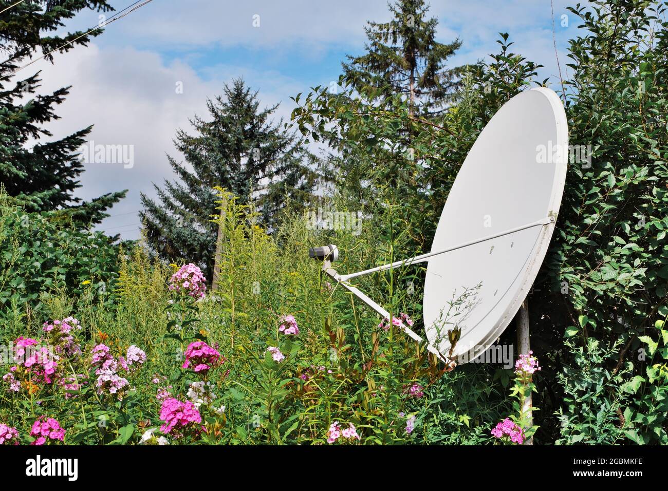 A satellite dish installed in rural areas for high-quality reception of a television signal. Selective focus. Stock Photo