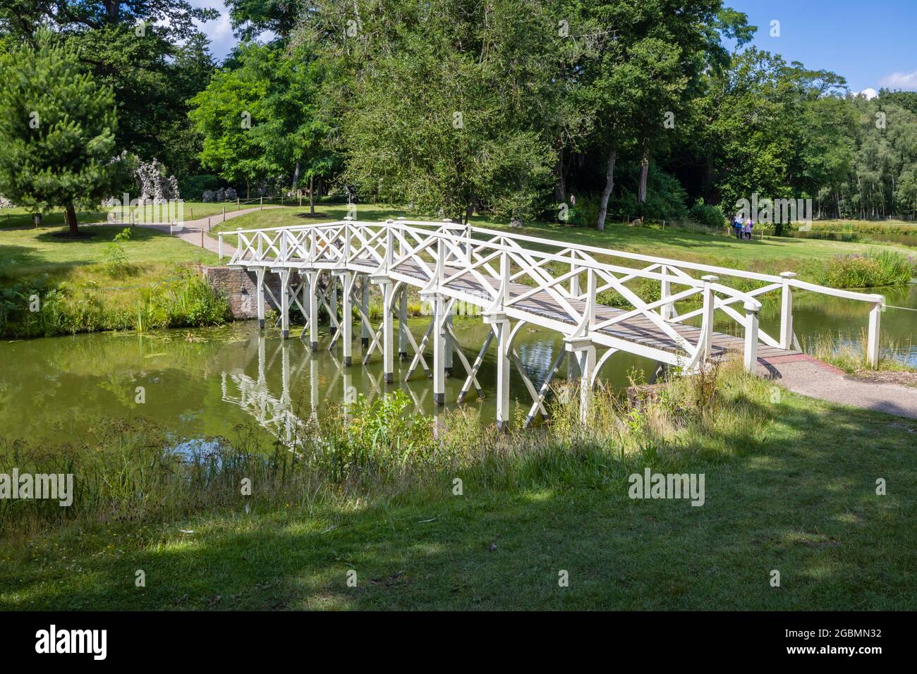 Reconstructed white wooden Chinese Bridge in the Hamilton Landscapes of Painshill Park, landscaped gardens in Cobham, Surrey, south-east England, UK Stock Photo