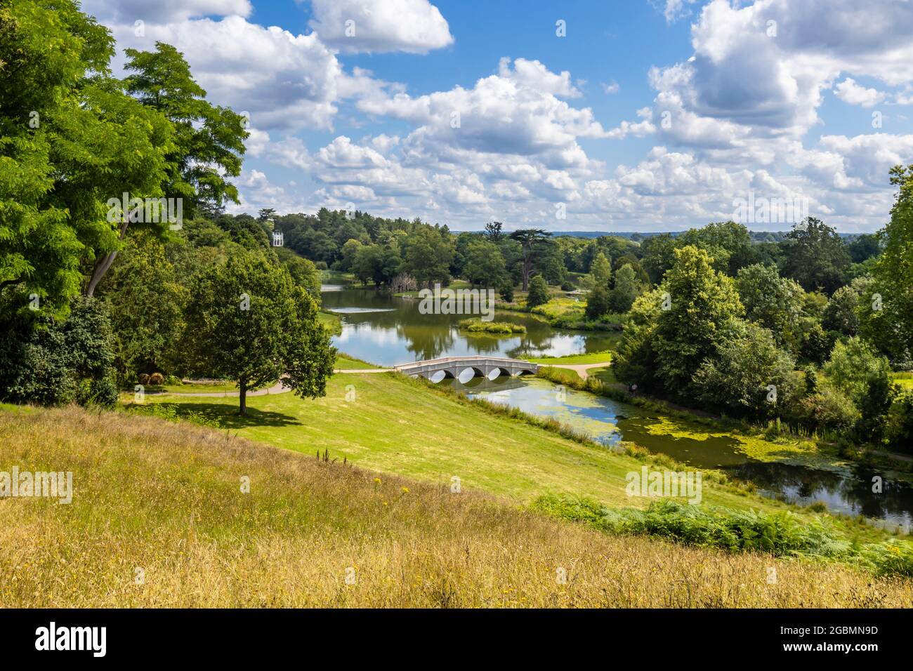 View of the Five Arch Bridge and lake in the Hamilton Landscapes of Painshill Park, landscaped gardens in Cobham, Surrey, south-east England, UK Stock Photo