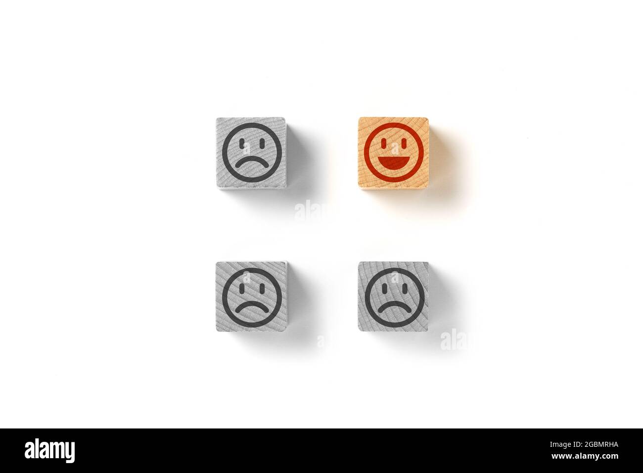Emoticon faces concept. Black and white sad. In color is happy. The one, election the best. Stock Photo