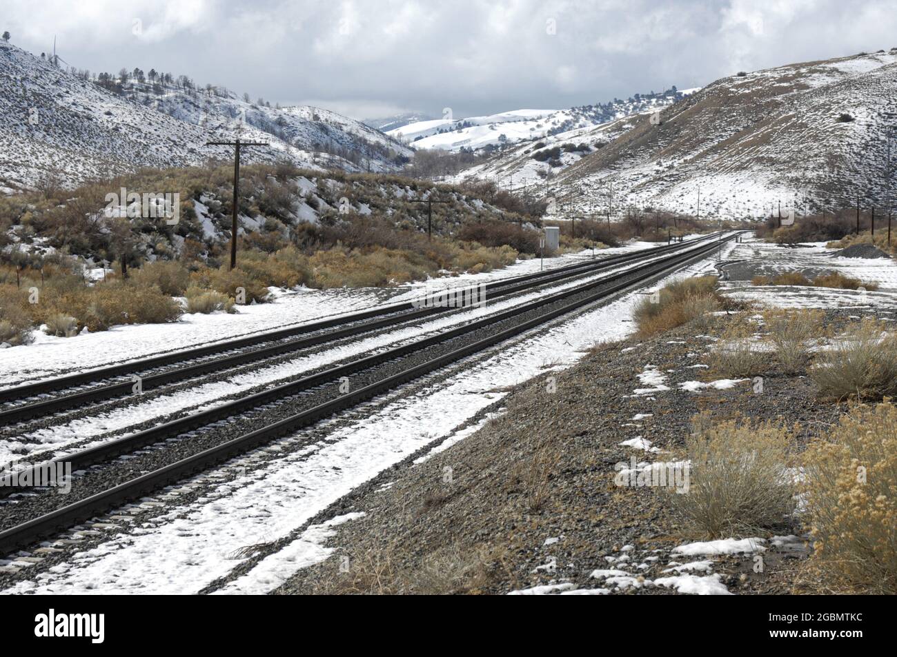 Railroad tracks in the snow between Mojave and Tehachapi, California Stock Photo