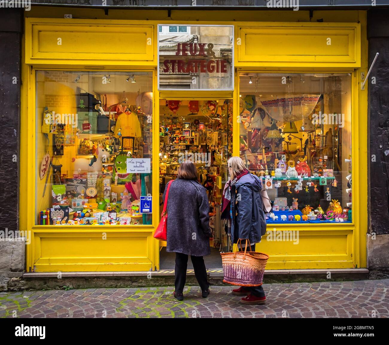 Rouen, France, Oct 2020, two women at the entrance of “Jeux et Strategie” a wooden games and toys store in Saint Nicolas street Stock Photo