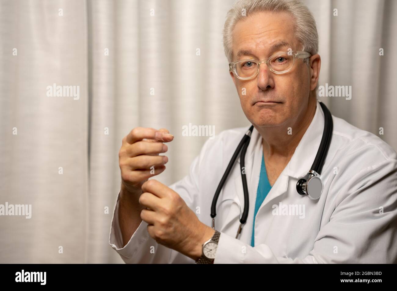 Medical doctor holding up empty space in hands Stock Photo