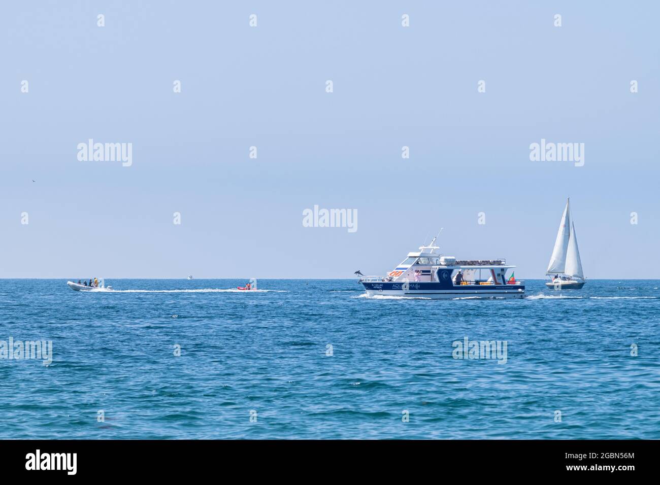 Different types of recreational boats cruising on the ocean, motor powered boats and wind powered boats. Sailing on the Atlantic at summer time. Stock Photo