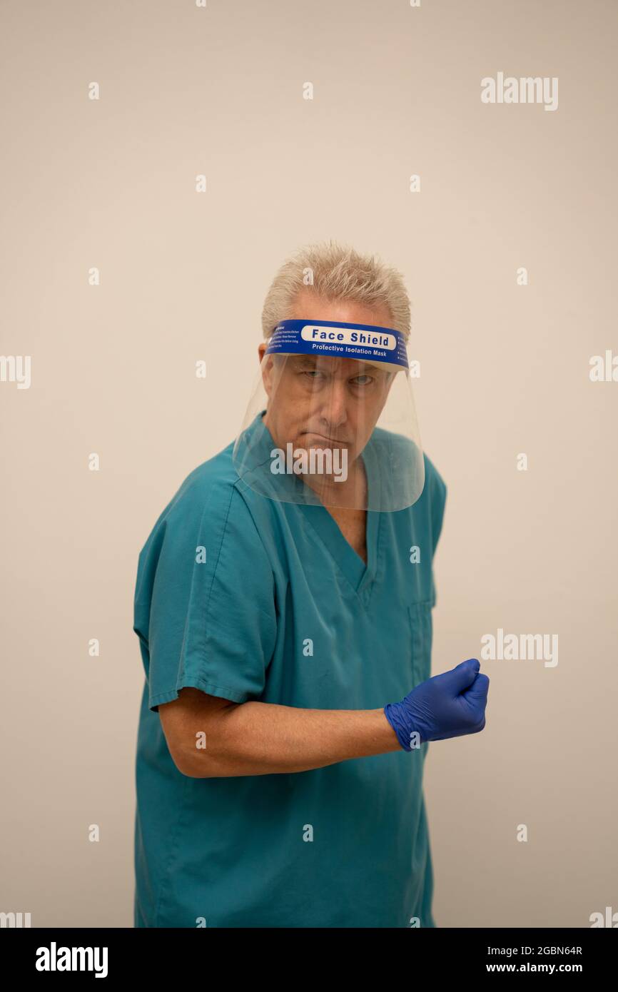 Medical doctor flexing his arm muscles Stock Photo