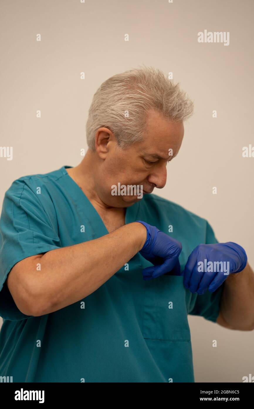 Photo of a doctor checking his pockets Stock Photo