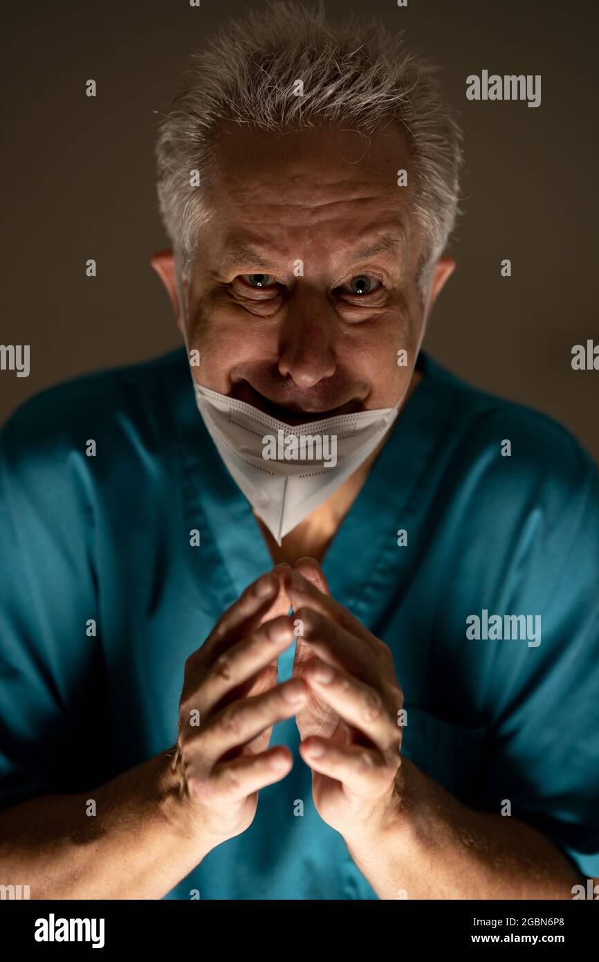 Photo of an evil doctor incorrectly wearing his face mask Stock Photo