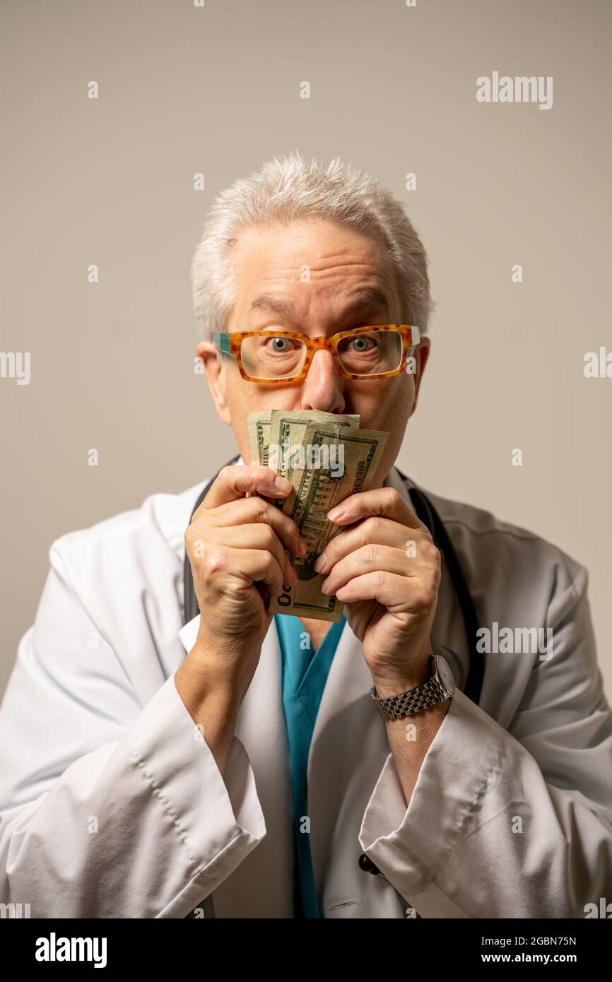 Wealthy doctor kissing his money Stock Photo