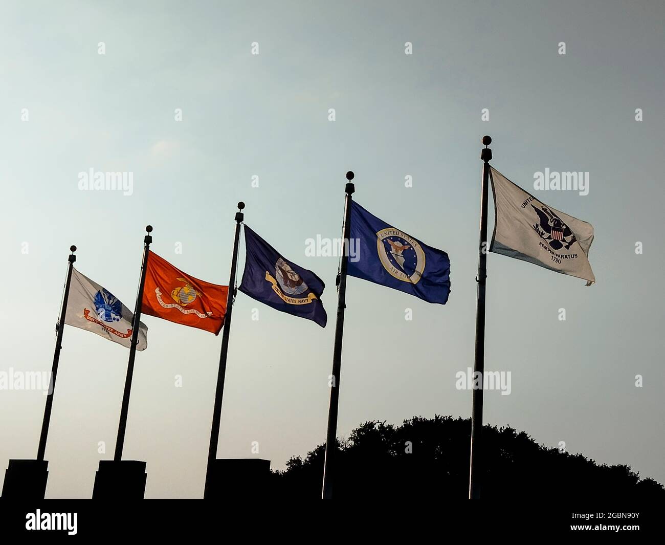Kansas City, Kansas. Armed Forces flags flying at memorial to priests