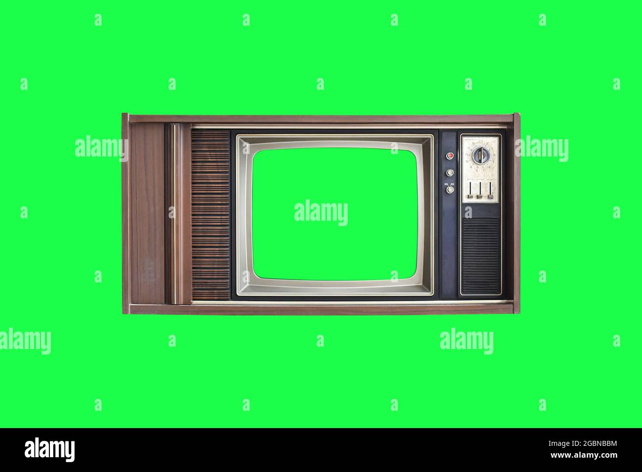 Vintage television with with green screen isolated on green background with clipping path. Stock Photo