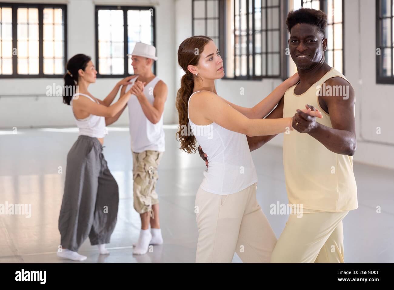 Positive people dancing twist together at dance studio Stock Photo Alamy