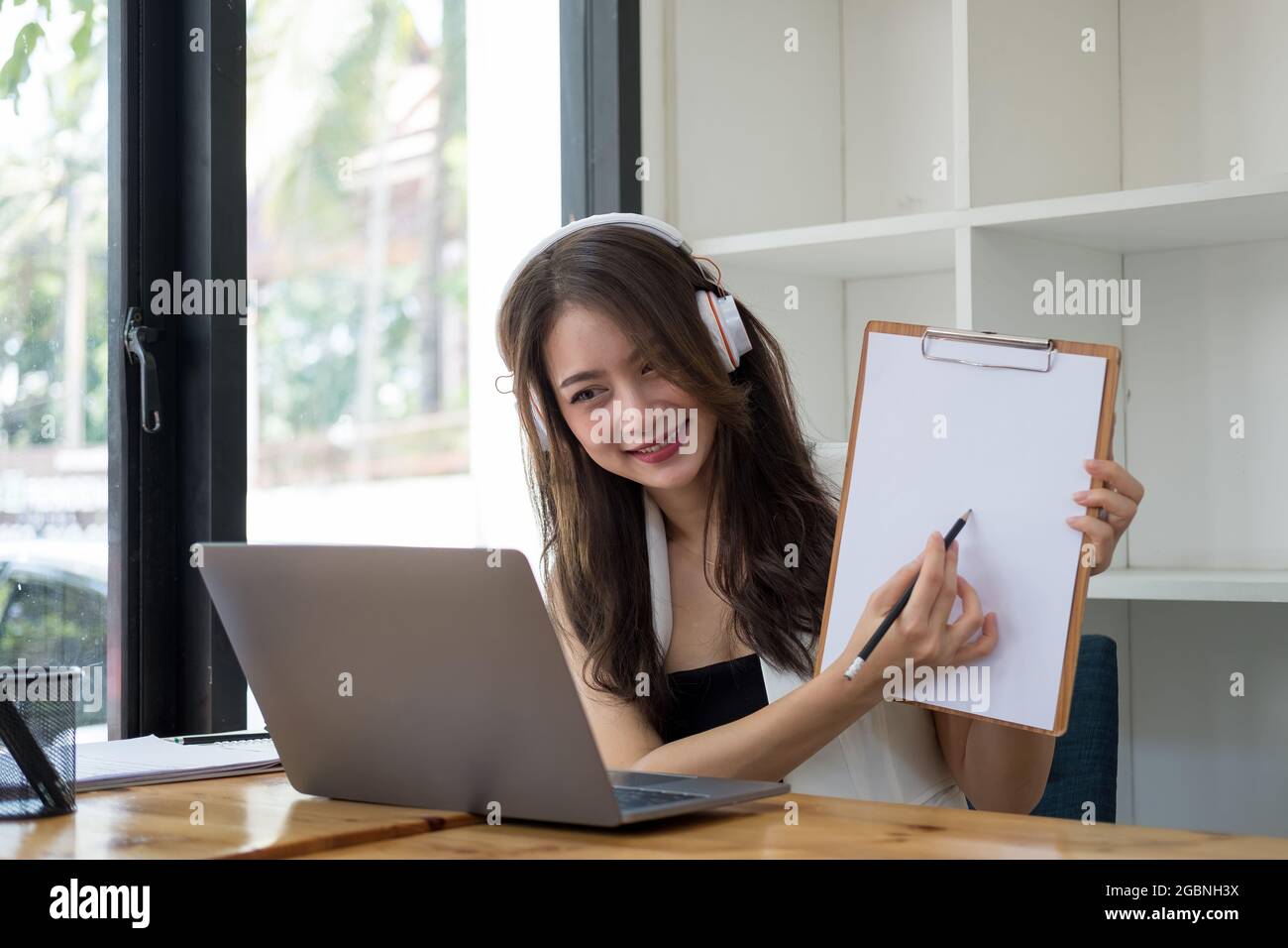 Asian woman teacher giving online lessons, Girl having video call on ...