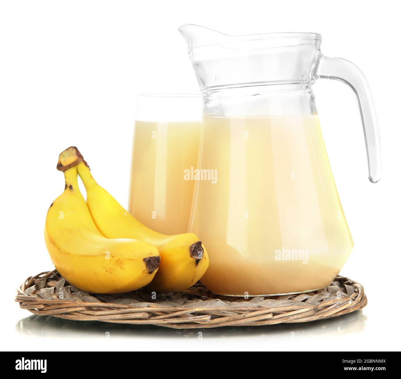 Full glass and jug of banana juice and bananas isolated on white Stock