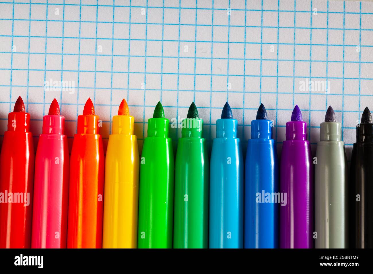 Opened multicolored markers on notebook, nobody Stock Photo