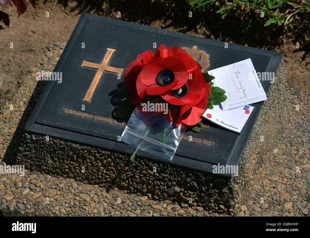 TAUKKYAN, MYANMAR (BURMA) - Oct 26, 2014: Red artificial poppies and remembrance cards placed on an unidentified Commonwealth war grave Stock Photo