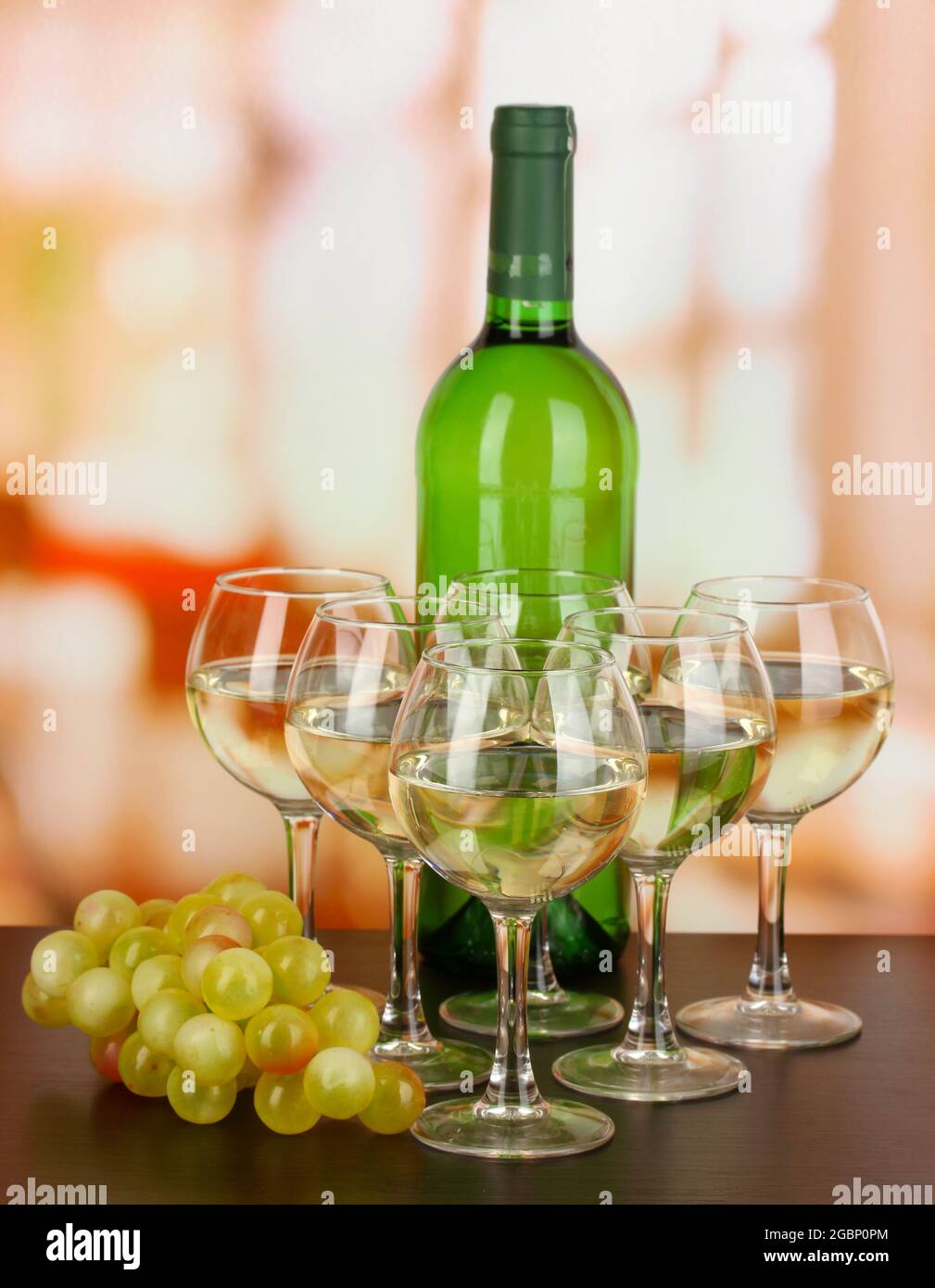White wine in glass and bottle on room background Stock Photo Alamy