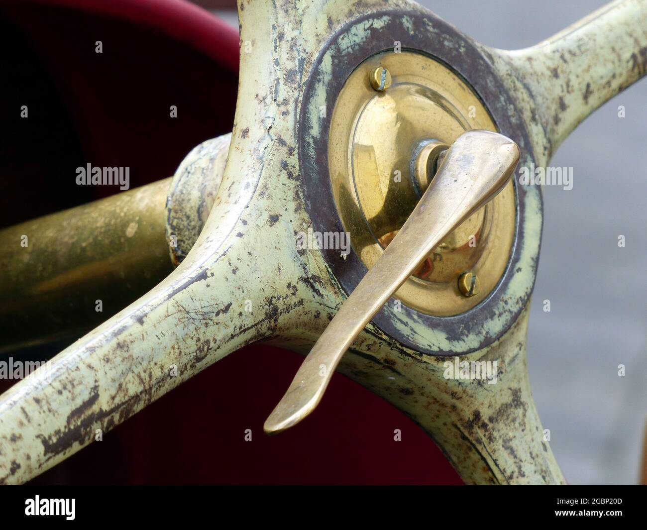 Brass wheel hub with clamping lever of an old four-spoke steering wheel of a vintage racing car Stock Photo