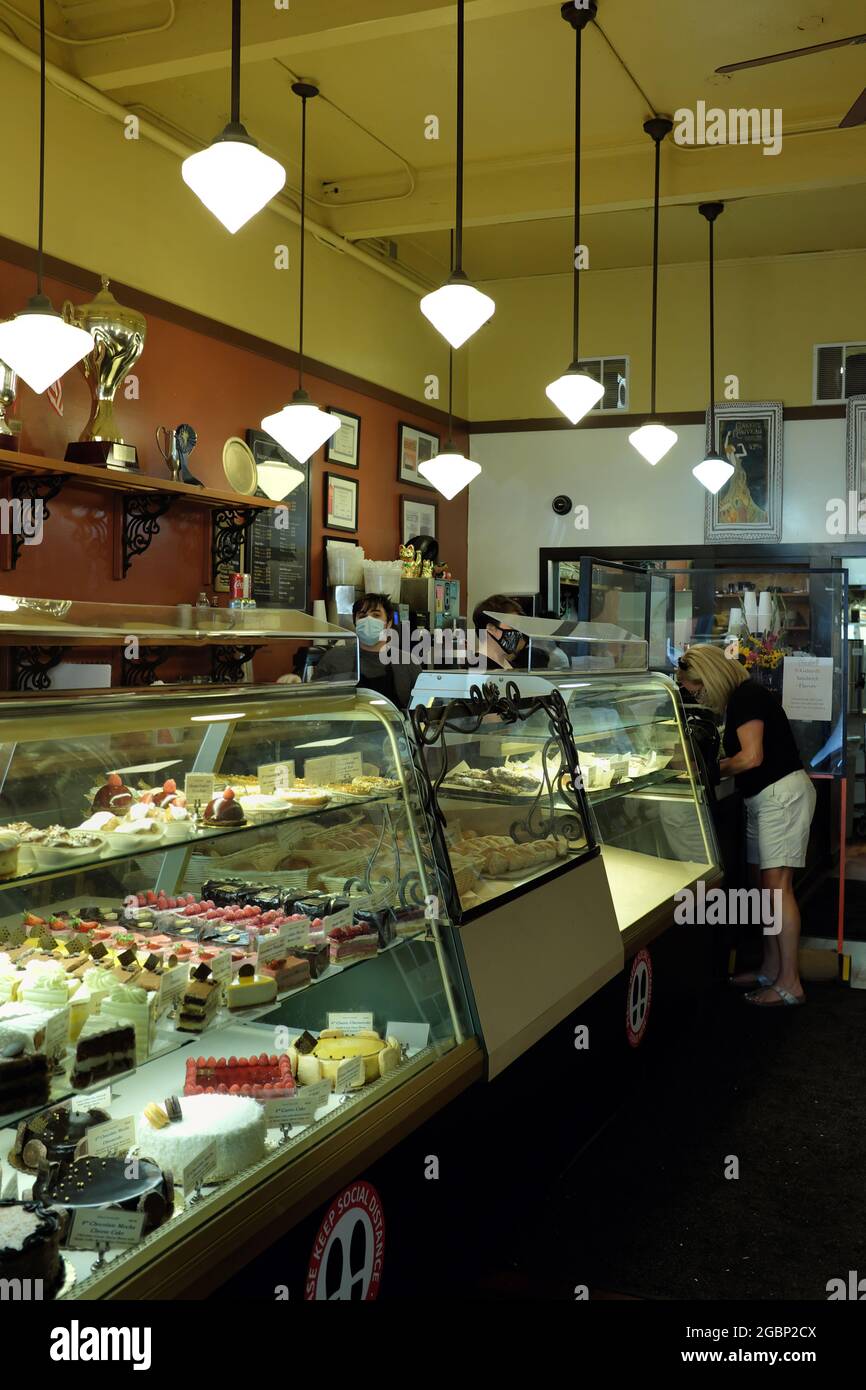 A woman makes a purchase at Bakery Nouveau in Seattle, WA. Stock Photo
