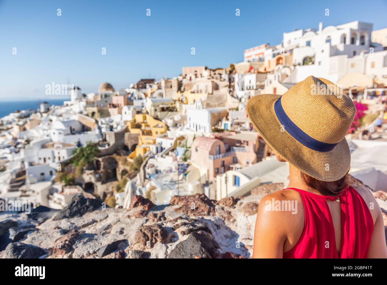 Travel vacation greece santorini woman tourist looking at Oia village view, luxury Europe destination holiday. Summer vacations Stock Photo