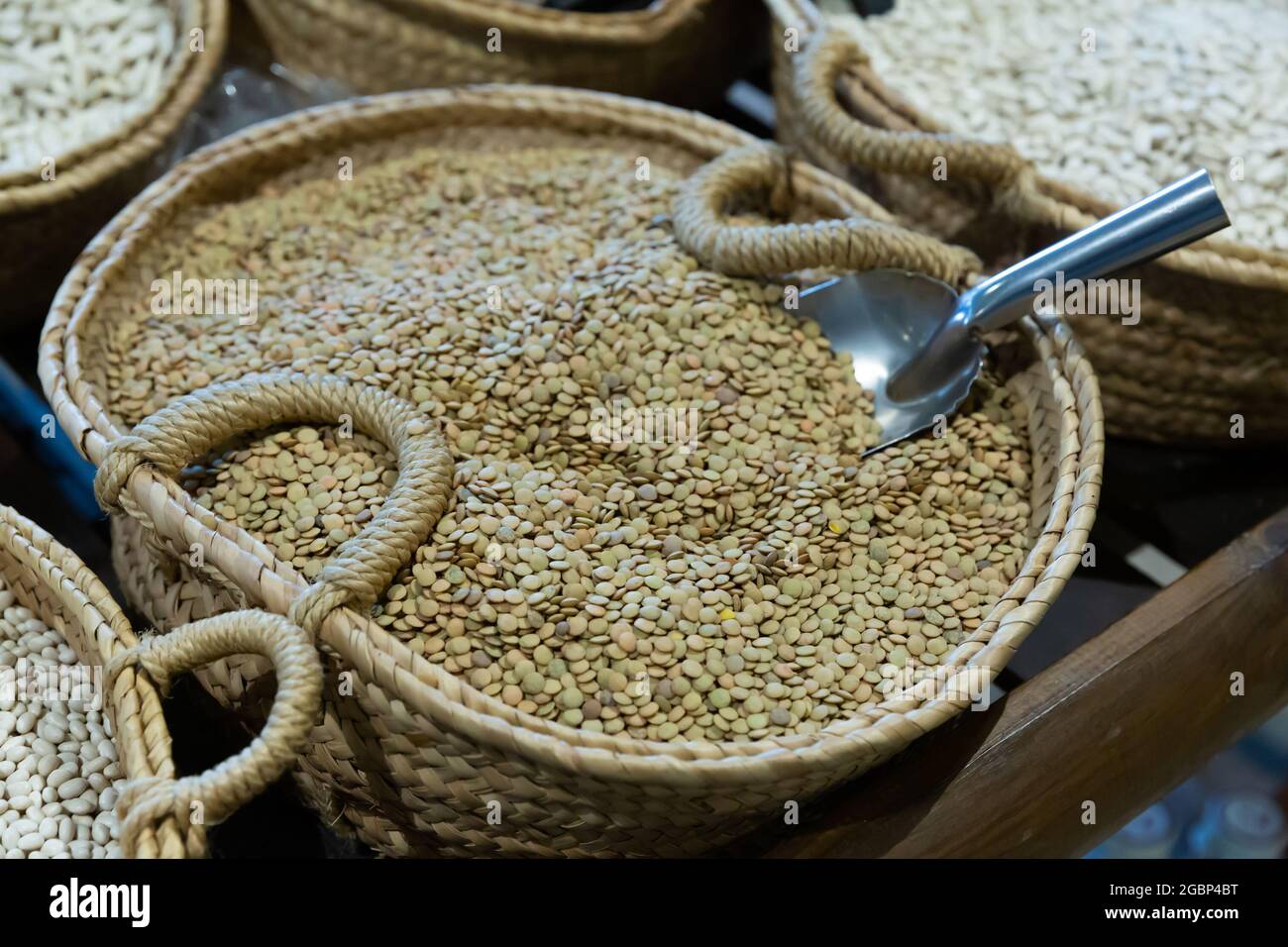 Lentils in wicker basket on shelf of grocery store Stock Photo Alamy