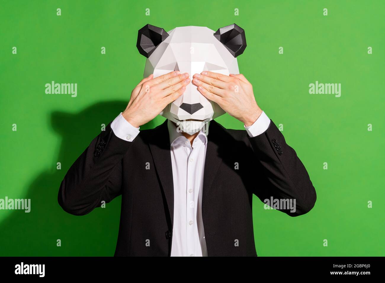 Photo of secretive incognito guy hands close eyes wear panda mask black