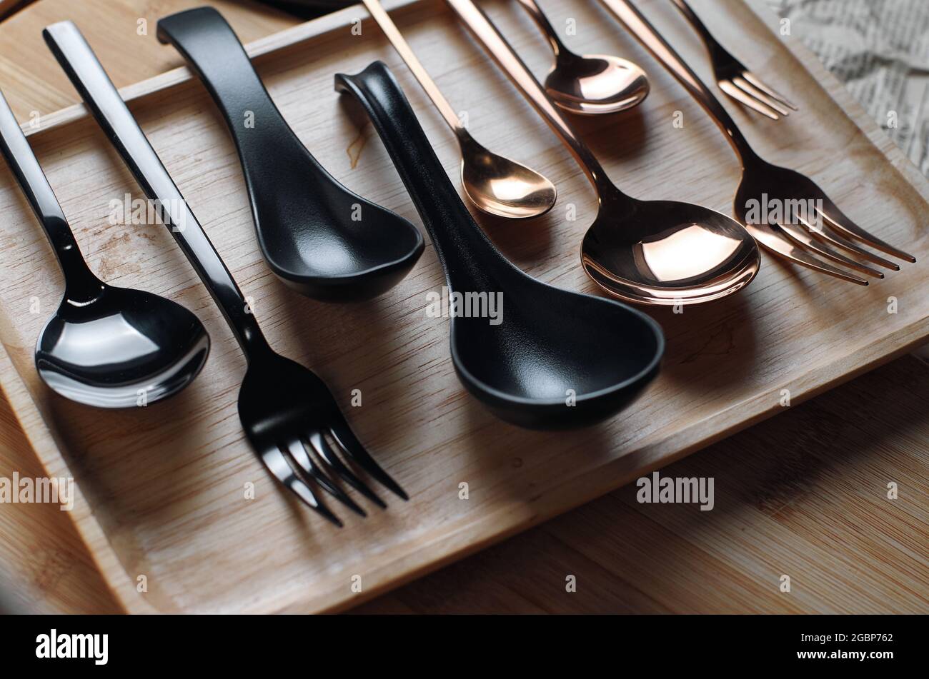 Cutlery is arranged on a wooden tray Stock Photo