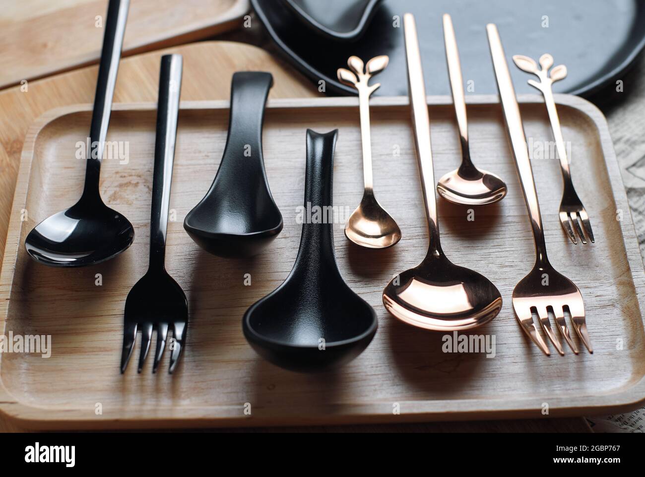 Cutlery is arranged on a wooden tray Stock Photo