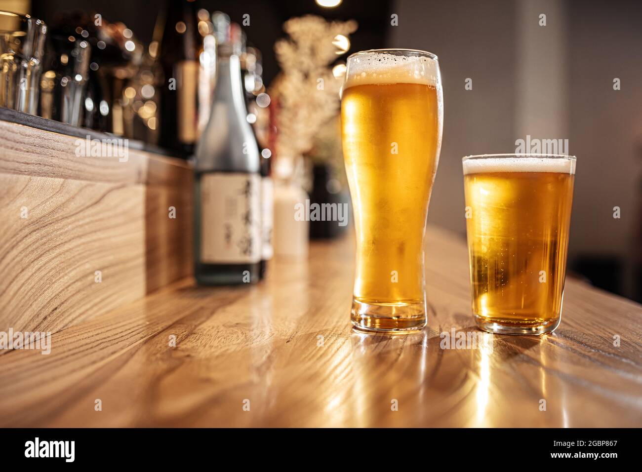 Two glasses of japanese light beer on a bar desk Stock Photo