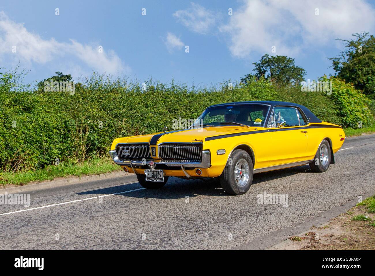 1967 60s sixties yellow American Mercury Cougar 2dr pony car  4949cc petrol muscle car en-route to Capesthorne Hall classic July car show, Cheshire, UK Stock Photo