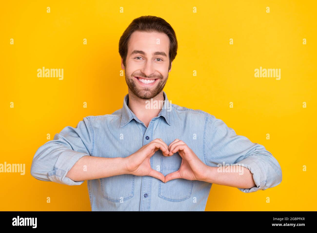 Photo Portrait Of Young Guy Smiling Showing Heart Shaped Sign Isolated On Bright Yellow Color Background Stock Photo Alamy Photo Portrait Of Young Guy Smiling Showing Heart Shaped Sign Isolated On Bright Yellow Color Background Stock Photo Alamy