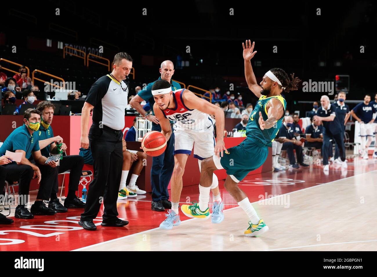 Tokyo, Japan, 5 August, 2021. Devin Booker of Team United States and Patty  Mills of Team Australia collide during the Men's Basketball Semifinal match  between USA and Australia on Day 13 of