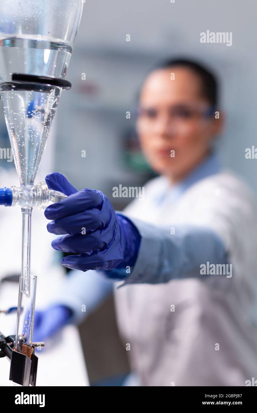 Specialist chemist woman working at biochemistry experiment using