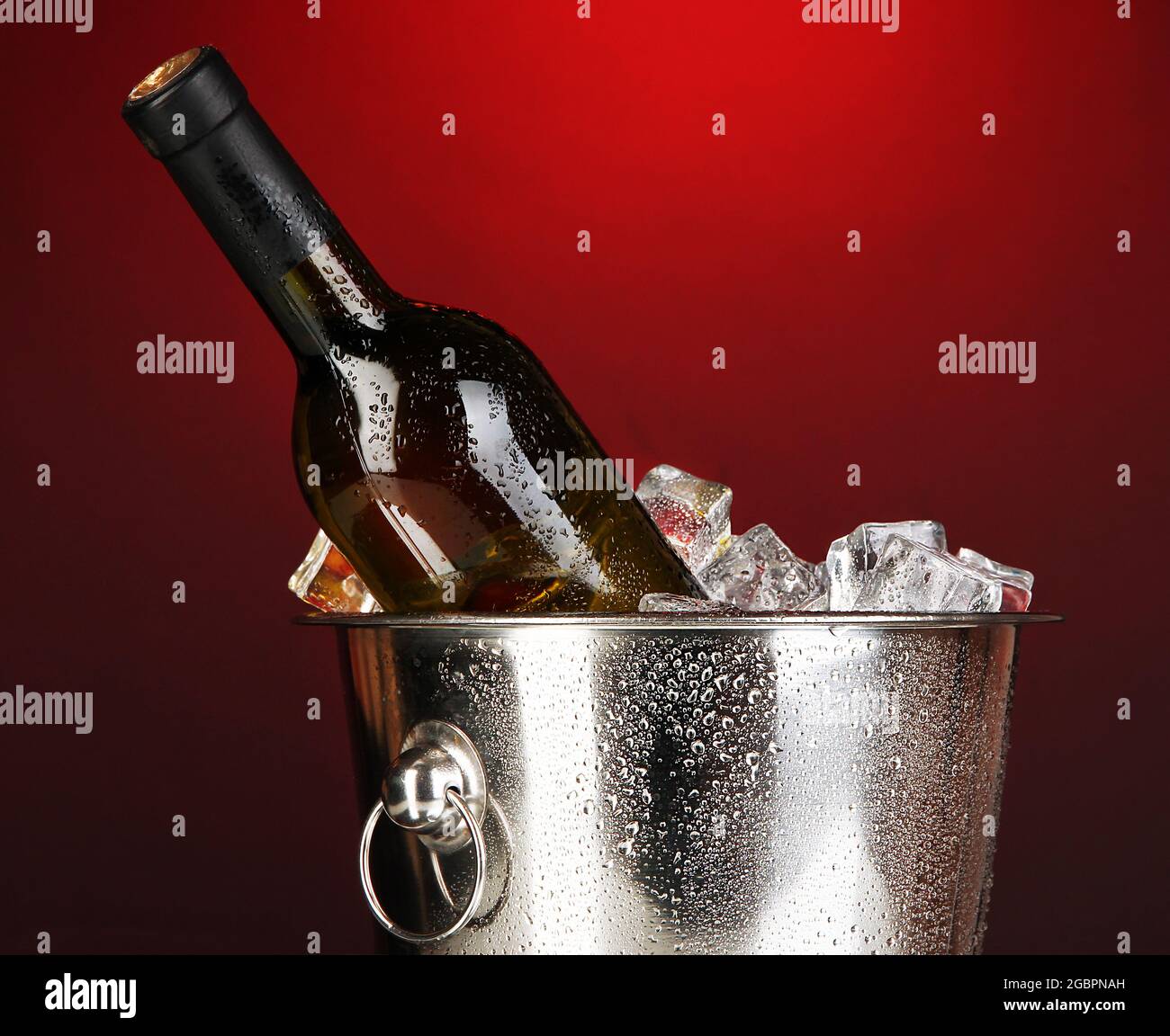 Bottle of wine in ice bucket on darck red background Stock Photo Alamy