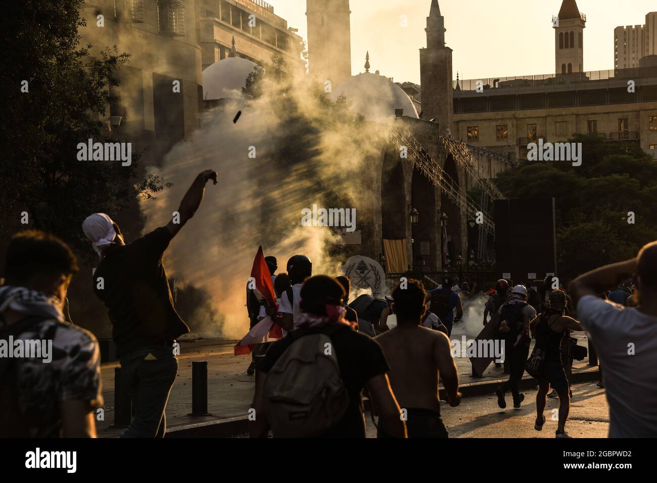 Beirut, Lebanon, 4 August 2021. People protesting failure to find those responsible for the Beirut Blast and hold them responsible throw stones at security forces deploying heavy tear gas. Stock Photo