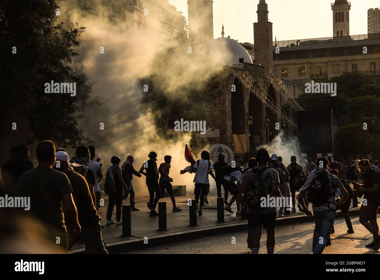 Beirut, Lebanon, 4 August 2021. People protesting failure to find those responsible for the Beirut Blast and hold them responsible throw stones at security forces deploying heavy tear gas. Stock Photo