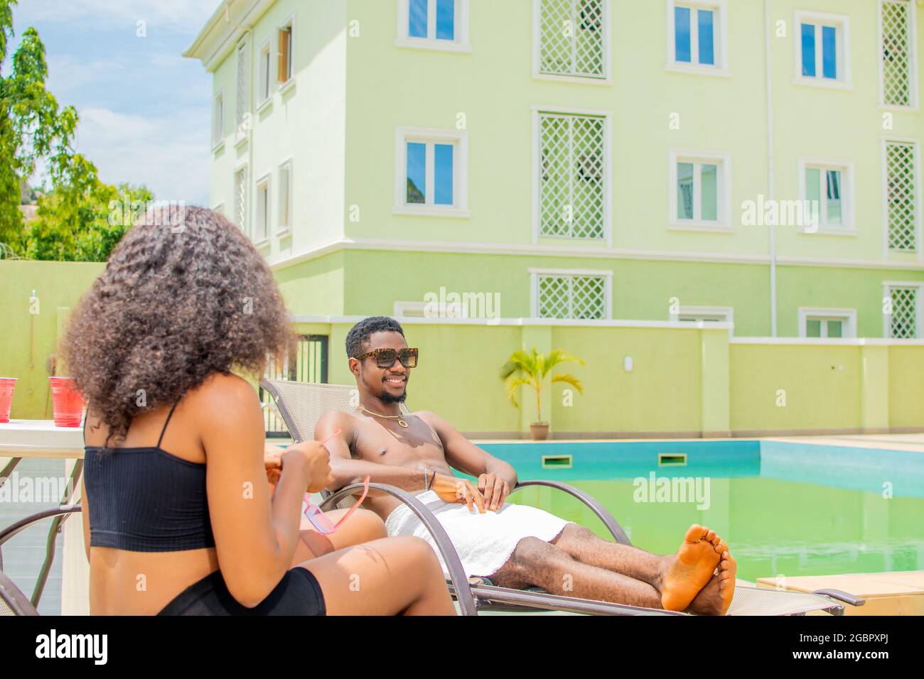 young black people chilling by the pool side Stock Photo