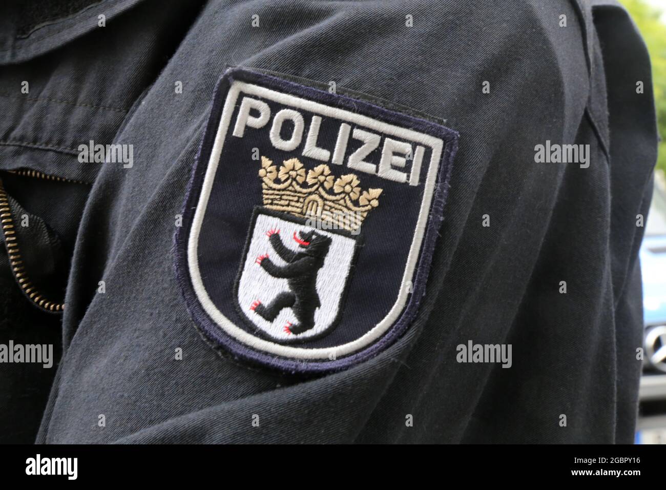 Coat of arms of the Berlin police on the combat outfit of a policeman ...