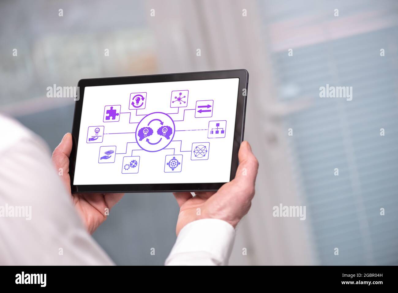 Knowledge sharing concept shown on a tablet held by a man Stock Photo